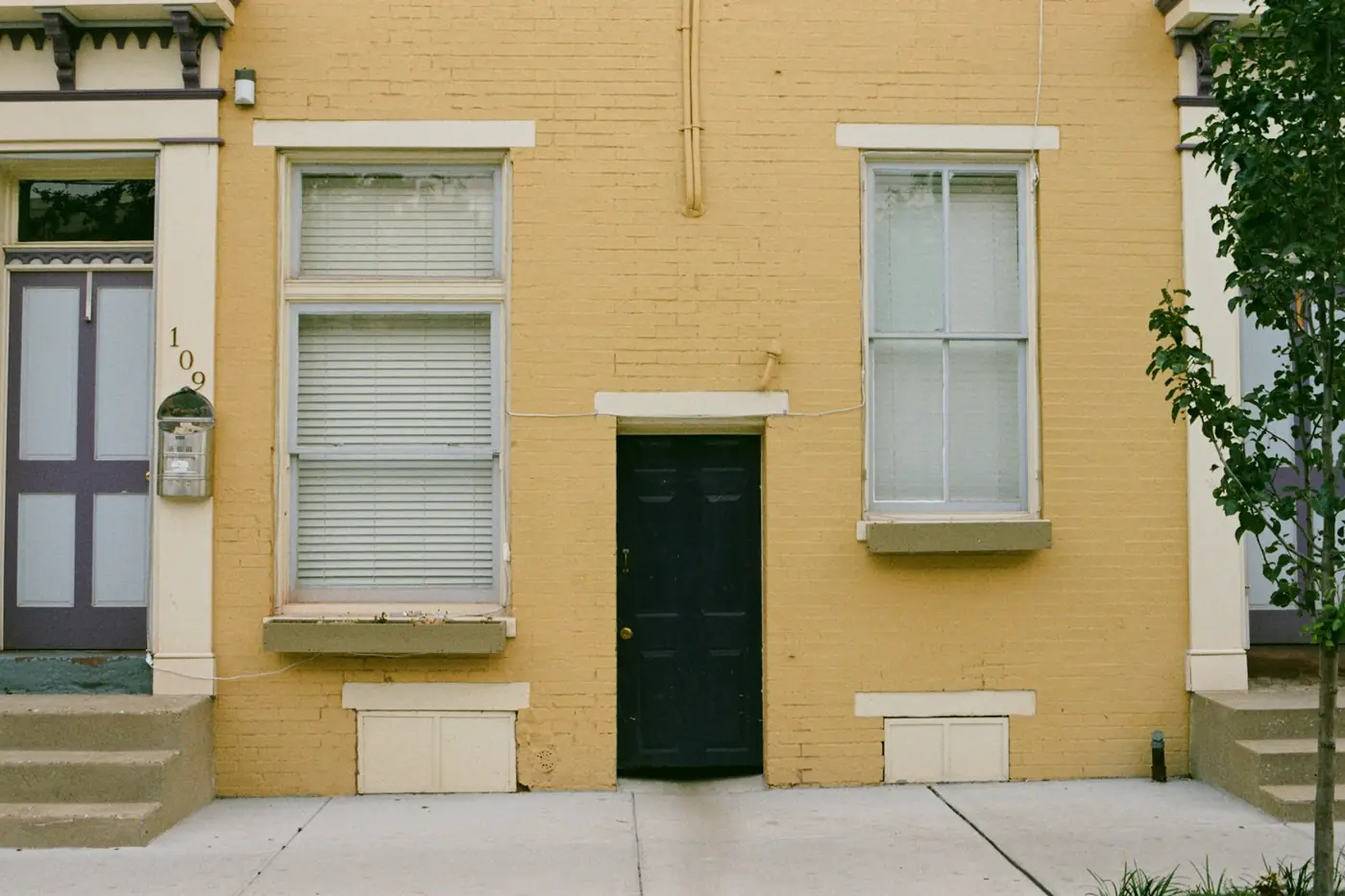 Brick row home with tall windows, a common style in older city neighborhoods
