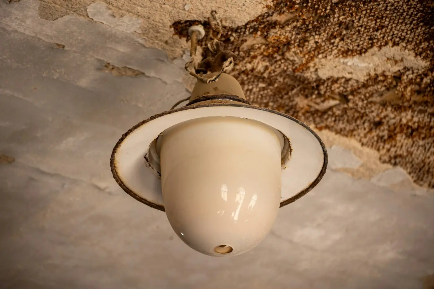 Water-stained ceiling around a light fixture caused by a hidden plumbing leak
