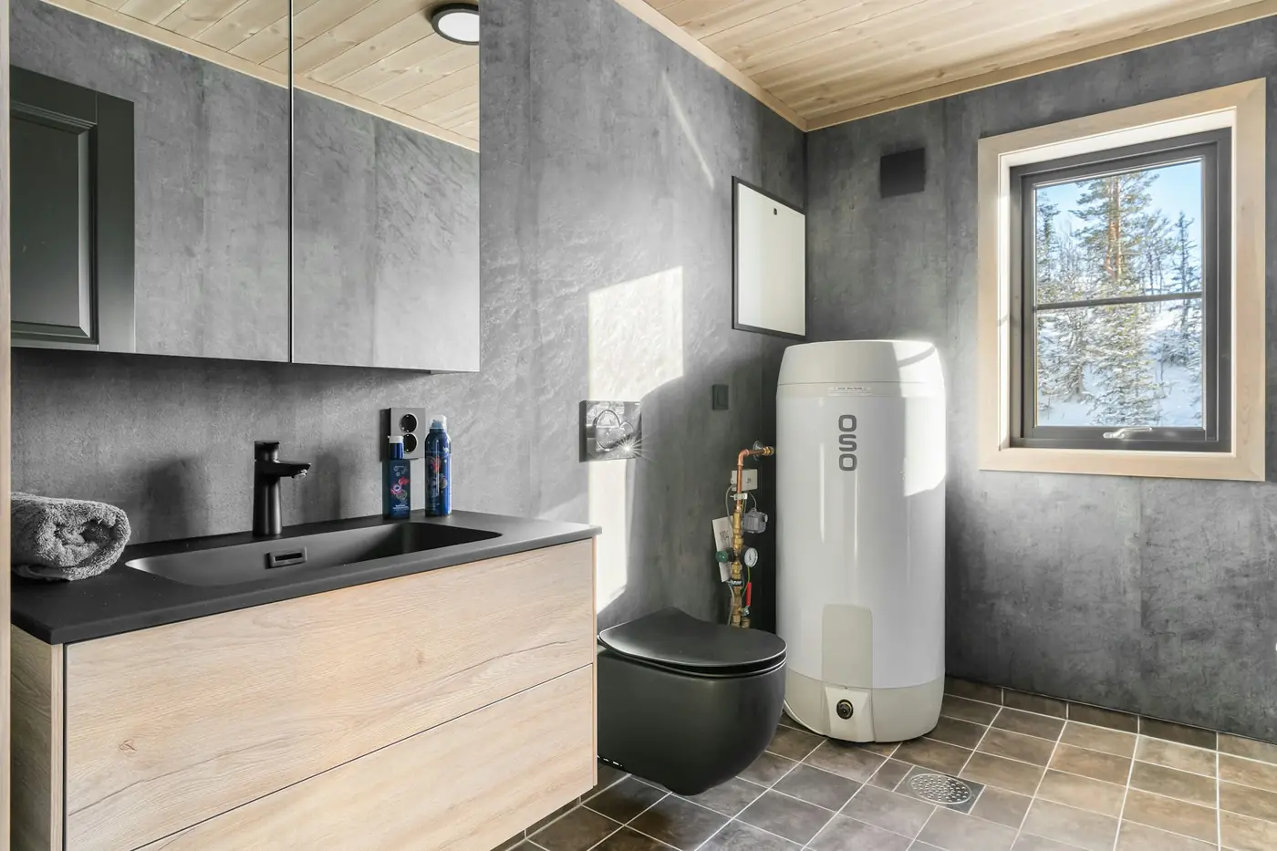 Electric water heater installed in a bathroom next to the sink