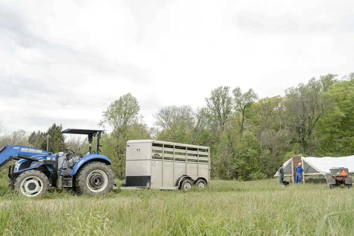 Tractor and trailer on a farm field in the countryside