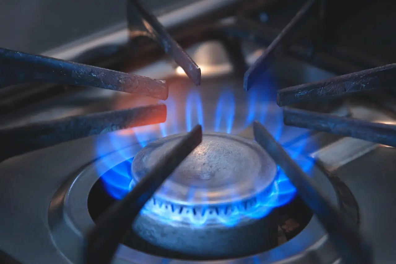 Blue flame on a gas stove burner connected to a home gas line