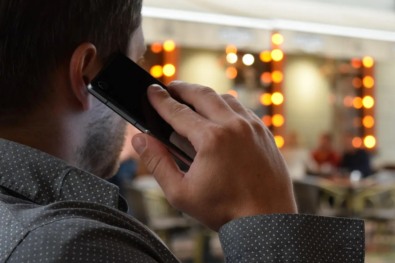 Man calling on his phone to book a plumber