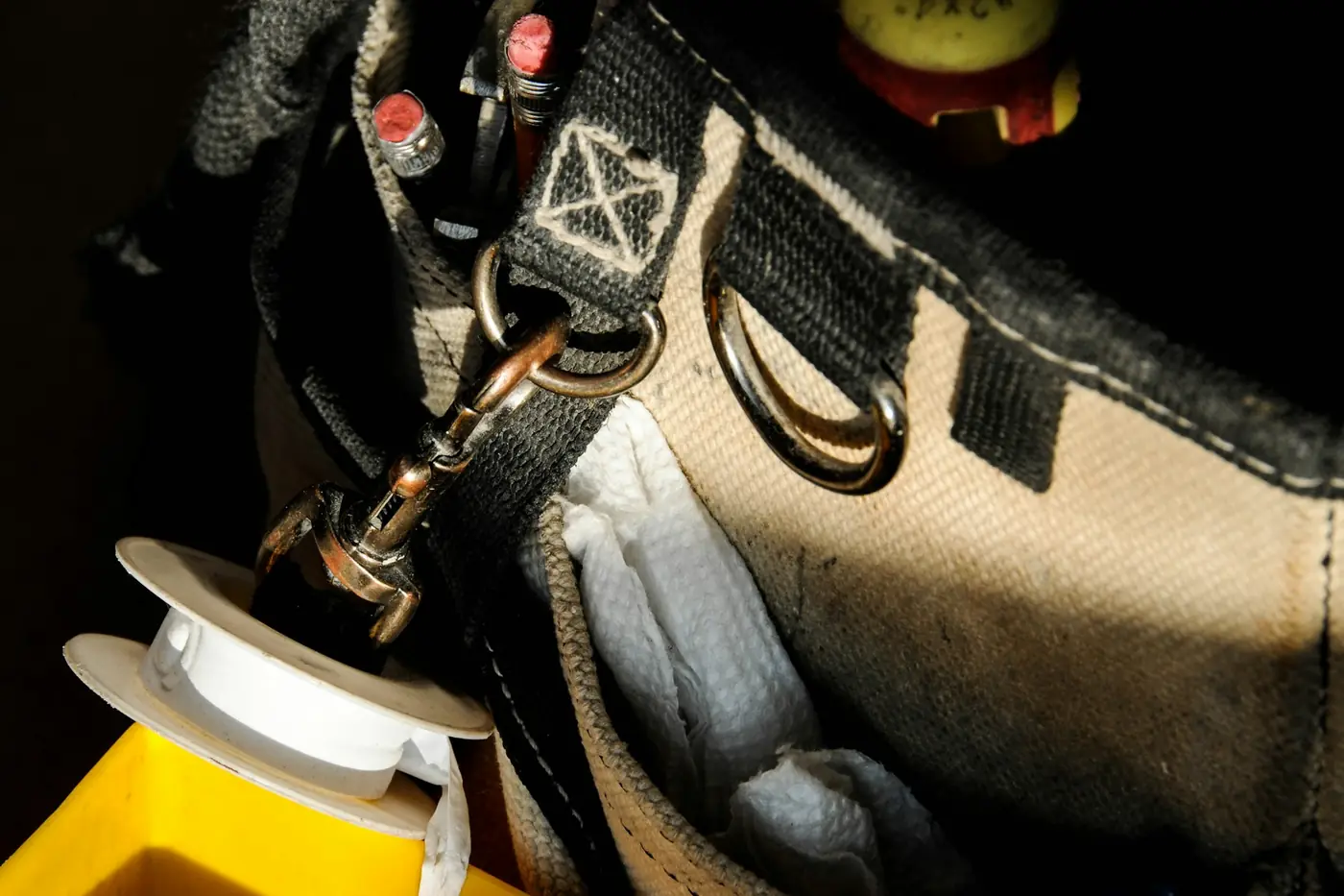 Plumber's tool bag packed with tools for a service call