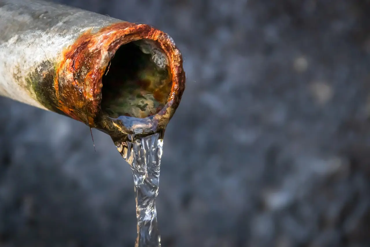 Old rusty water pipe leaking water