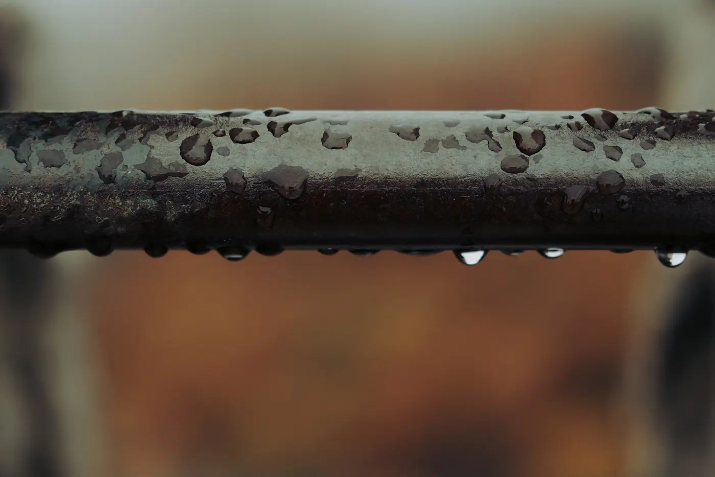 Water droplets forming on a leaking metal pipe