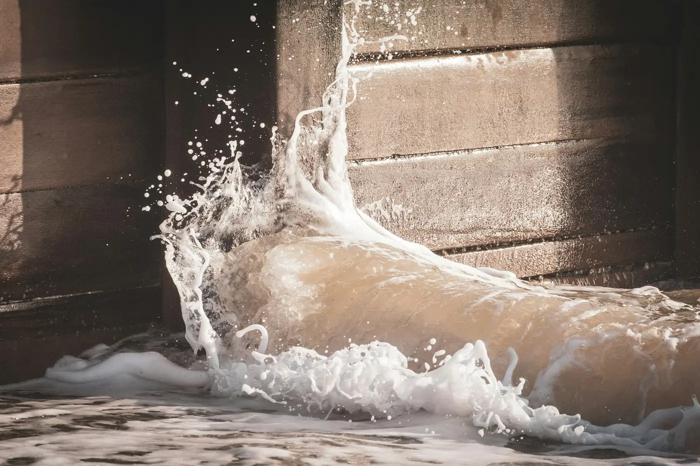 Water rushing across a floor from a burst pipe, a plumbing emergency